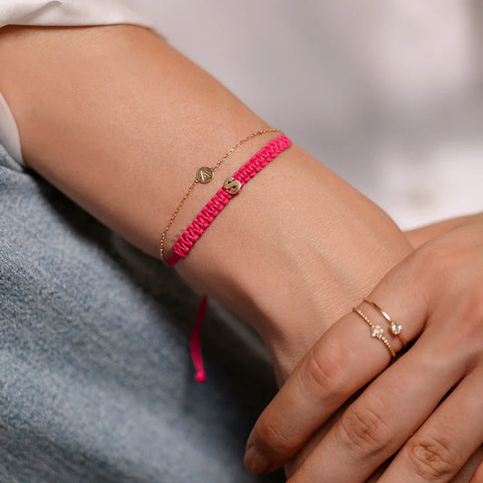 BRACCIALE TESSUTO FUCSIA CON LETTERA ORO - Tangredi Gioielleria
